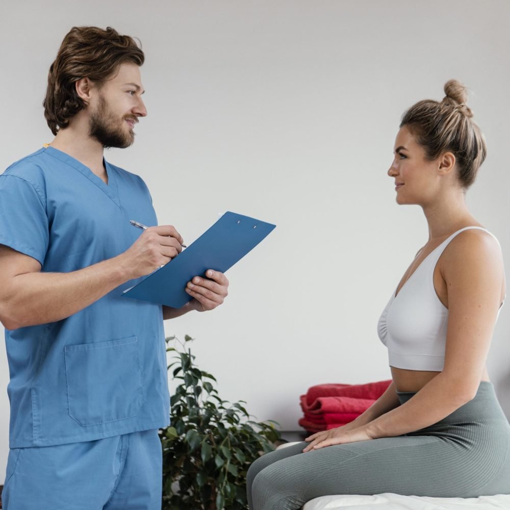 side-view-male-osteopathic-therapist-with-female-patient-signing-clipboard-clinic
